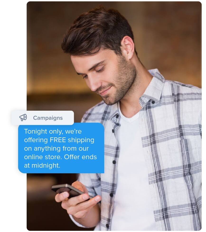 A man looks at his phone with a text message that reads,