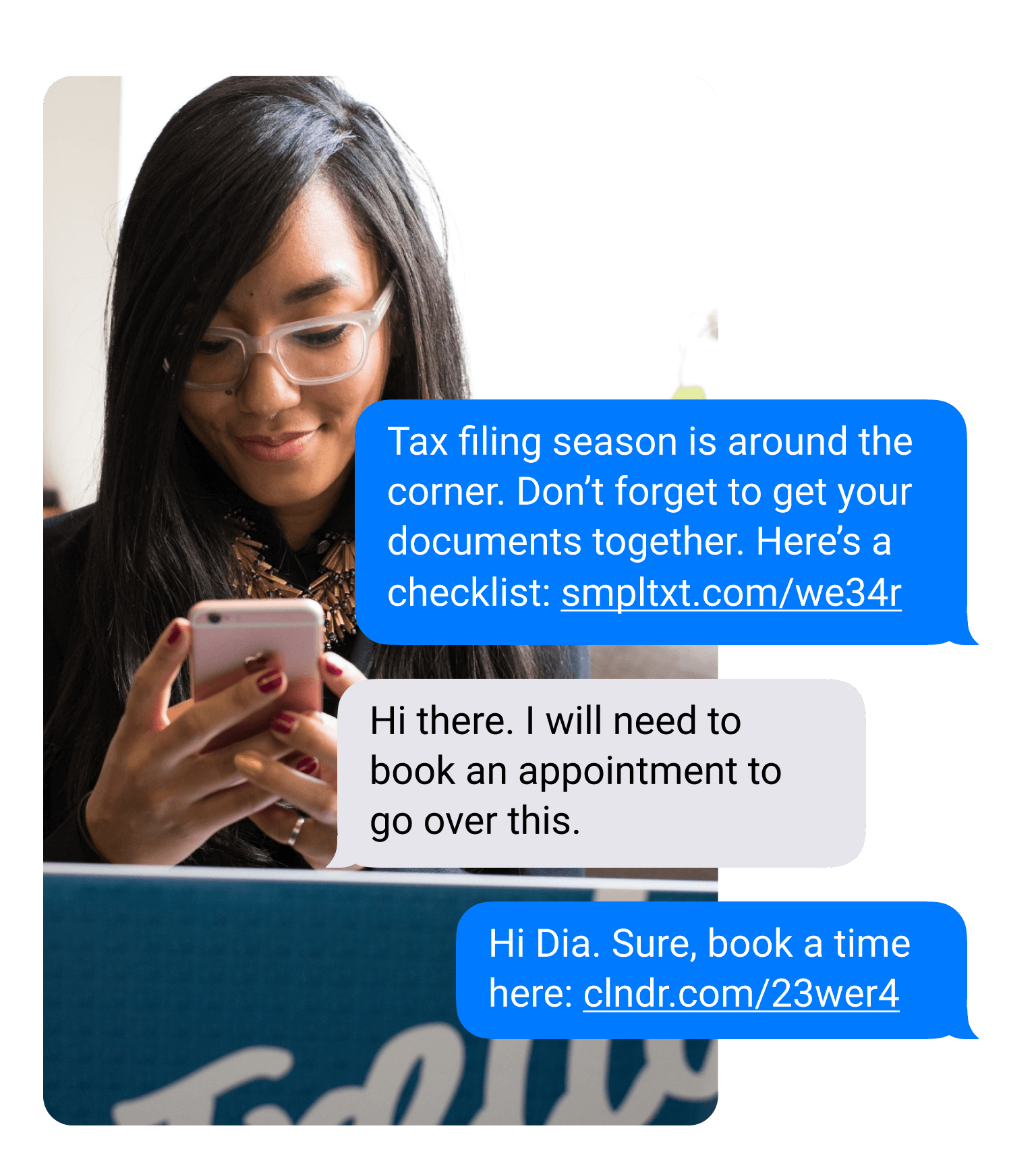 Woman looks at her phone in a professional setting. She receives a text that reads 